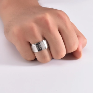Close-up of 12mm wide stainless steel spinner ring with engraved Chinese Heart Sutra