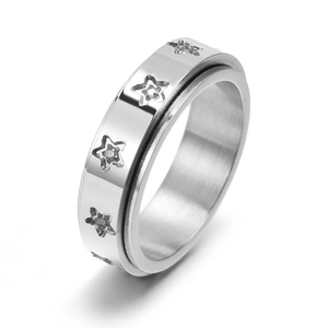 Polished stainless steel spinner ring with inlaid star patterns and zircon crystals