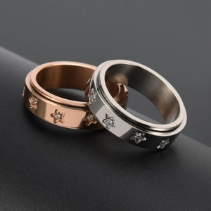 Rotating stainless steel spinner rings with star patterns and zircon stones in rose gold and silver