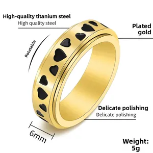 Detail view of 6mm golden titanium steel spinner ring with black heart patterns