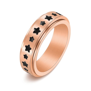 Rose gold rotating stainless steel ring with black star patterns and brushed metal finish