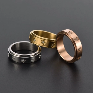 Three spinner star rings in silver, gold, and rose gold finishes with CZ inlay for stress relief