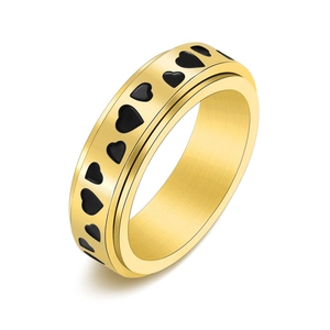 Golden stainless steel spinner ring with black heart patterns in a 45-degree angle view