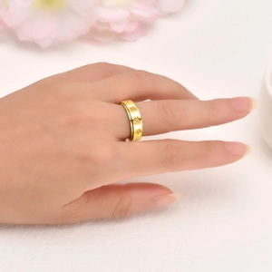 Detail of a rotating gold star ring with zircon inlay worn on the index finger