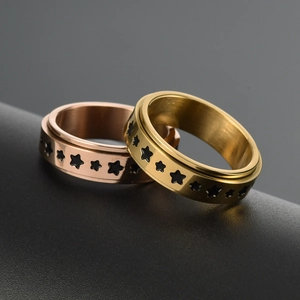 Minimalist stainless steel spinner ring with gold and rose gold rotating star pattern