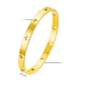 Detail view of 6mm wide gold titanium steel bangle with hollow star pattern and 20g weight
