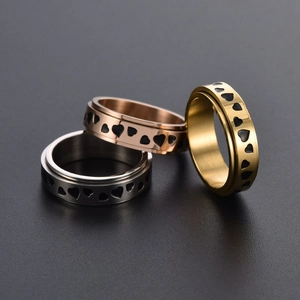 Three-piece stainless steel heart spinner rings in silver, gold, and rose gold