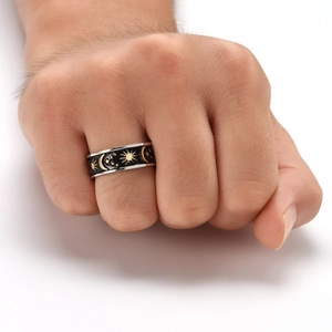 Detail view of rotating celestial ring featuring moon star sun motifs and black enamel