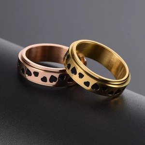 Gold and rose gold stainless steel spinning ring with continuous black heart patterns
