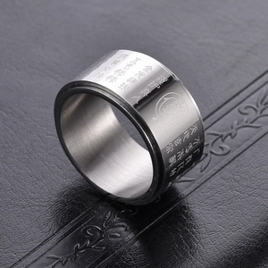 Rotating stainless steel spinning ring with engraved Taoist mantras and polished finish