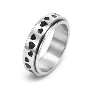 Detail of silver stainless steel ring featuring engraved black heart patterns and polished finish