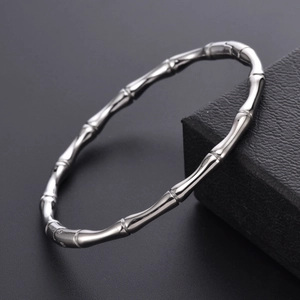 Sleek silver stainless steel bamboo joint bracelet for women on black jewelry box