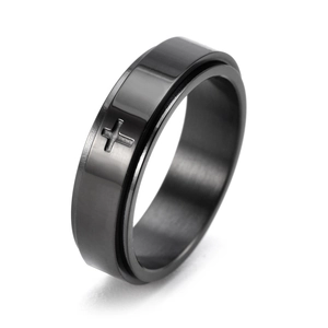 Detail of black brushed titanium spinner ring featuring a cross pattern on a rotating band