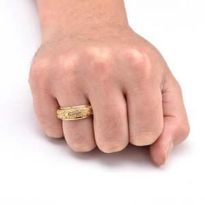 Macro detail of men's vintage spinning astronomical ring with gold baroque relief pattern