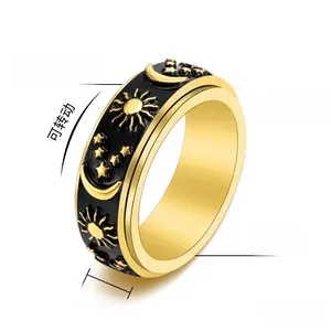 Detailed view of 8mm wide celestial spinner ring with sun, moon and star engraving