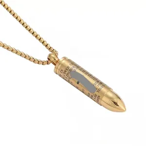 Gold stainless steel bullet pendant necklace with Lord's Prayer engraving on white background