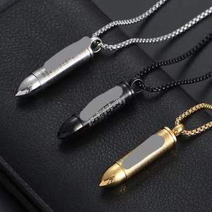 Macro detail of bullet pendants in silver black and gold with engraved scripture on leather