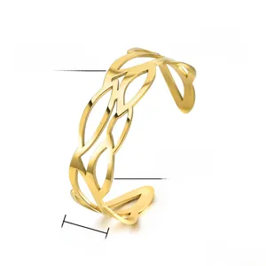 Detail view of 19mm wide hollow leaf texture on gold plated stainless steel cuff bracelet