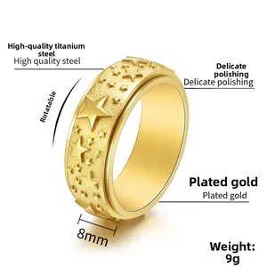 Detail view of 8mm gold titanium steel spinner ring featuring engraved star patterns