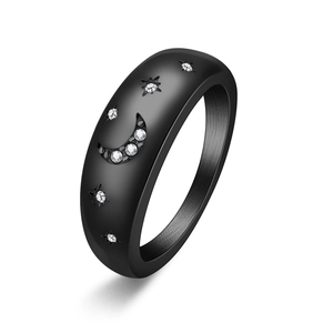 Close-up of matte black star and moon ring featuring sparkling white crystal inlay