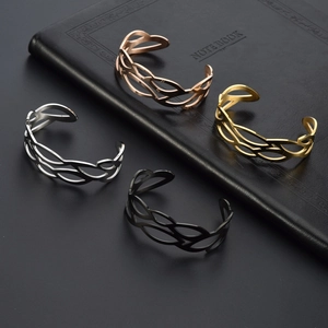 Set of four hollow wave-pattern stainless steel open bangles in gold, silver, rose gold and black