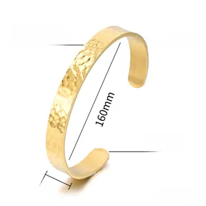 Detail view of 8.5mm wide hammered texture gold cuff bracelet in polished steel