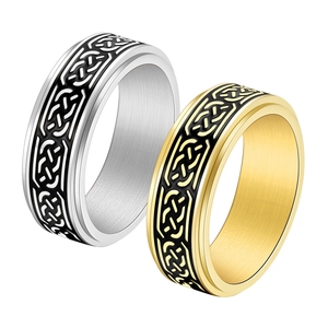 Detail view of Celtic knot pattern on silver and gold stainless steel spinner rings