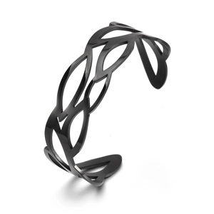Detail view of black cut-out wave pattern on a stainless steel open C-cuff bracelet