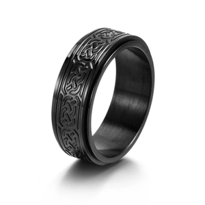 Detail of a matte black spinner ring with Celtic knot relief and vintage stainless steel finish