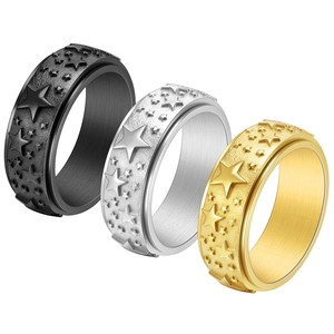 Three-piece stainless steel spinning rings with embossed star patterns in black, gold, and silver