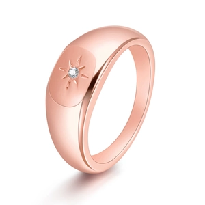 Minimalist 18K rose gold signet ring for women featuring a starburst zircon setting