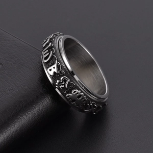 Vintage stainless steel spinning Pixiu ring with embossed mantra on a black leather base