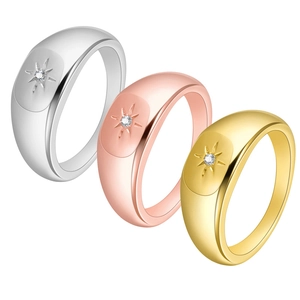 Detailed trio of gold, rose gold and silver rings with starburst set cubic zirconia