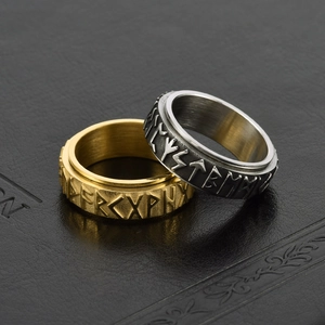 Vintage Viking runes spinner ring in gold and silver finish on black leather background