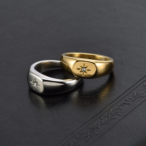 Minimalist 18K gold and silver starburst signet ring with cubic zirconia inlay