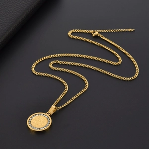Golden Tree of Life pendant necklace with white crystals on a black leather background