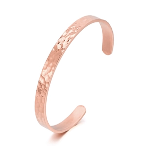 Detailed view of hammered texture on rose gold stainless steel cuff bracelet