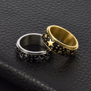 Stainless steel spinner ring with embossed metal stars on black band for stress relief