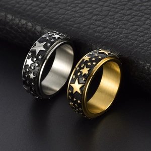Vintage stainless steel spinner ring with engraved stars in silver and gold finish