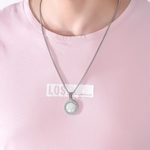 Detailed close-up of Tree of Life pendant with sparkling crystals on a silver chain