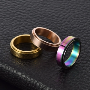 Brushed stainless steel spinner rings in gold, rose gold and rainbow on black leather