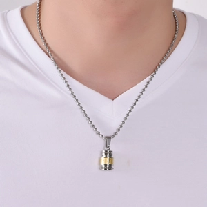 Detailed view of bicolor titanium steel cylinder pendant on a ball chain for men