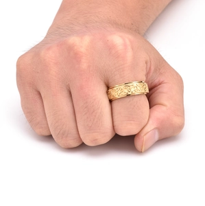 Detail view of gold spinner ring with Celtic Knot patterns worn on a hand