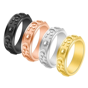 Detail of 6mm celestial spinner rings with sun moon stars in four metallic finishes