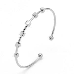 Detail of silver C-shape open bracelet with six movable geometric cube beads
