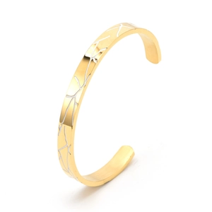 Detail shot of golden C-shaped open bracelet with white tree-like etched patterns