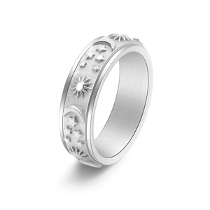Spinner ring with engraved sun moon stars pattern and matte finish relief