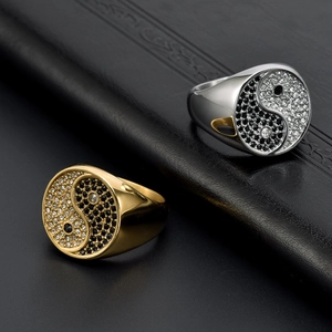 Men's gold and silver tai chi rings with black and white zircon inlay on leather background