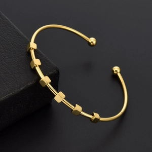 Minimalist gold titanium steel C-shape cuff bracelet with square beads on black jewelry box