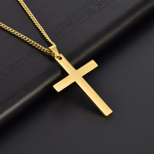 Polished gold stainless steel cross pendant necklace on a premium black textured background